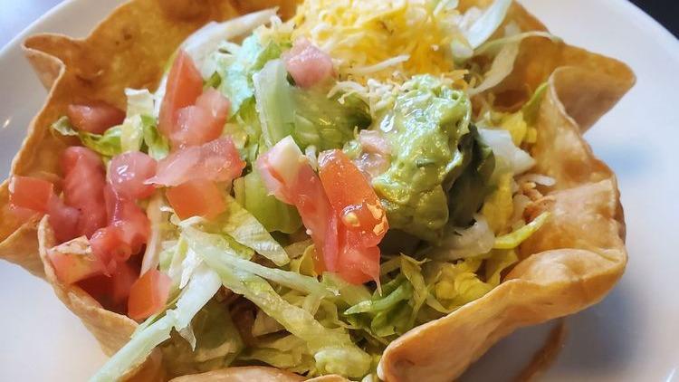 Fajita Taco Salad · A crispy ﬂour tortilla with your choice of steak or chicken with sautéed bell pepper, onion and tomato. Topped with fresh lettuce, tomato, sour cream and cheese.
