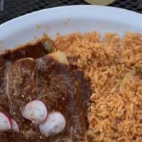 Enchilada De Mole · This great dish is made of three fresh corn tortillas ﬁlled with shredded chicken and topped...