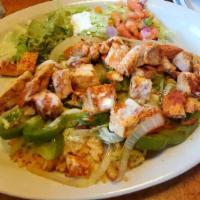 Arroz Con Pollo · Grilled chicken strips prepared with onion, bell pepper and tomatoes. Served on a bed of ric...