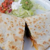 Garden Quesadilla · This delicious quesadilla is stuffed with cheese, fresh vegetables, sautéed green, yellow an...