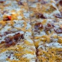 Fantasy Chicken Pizza · Ranch sauce, shredded teriyaki chicken, bacon, mozzarella cheese, and cheddar cheese.