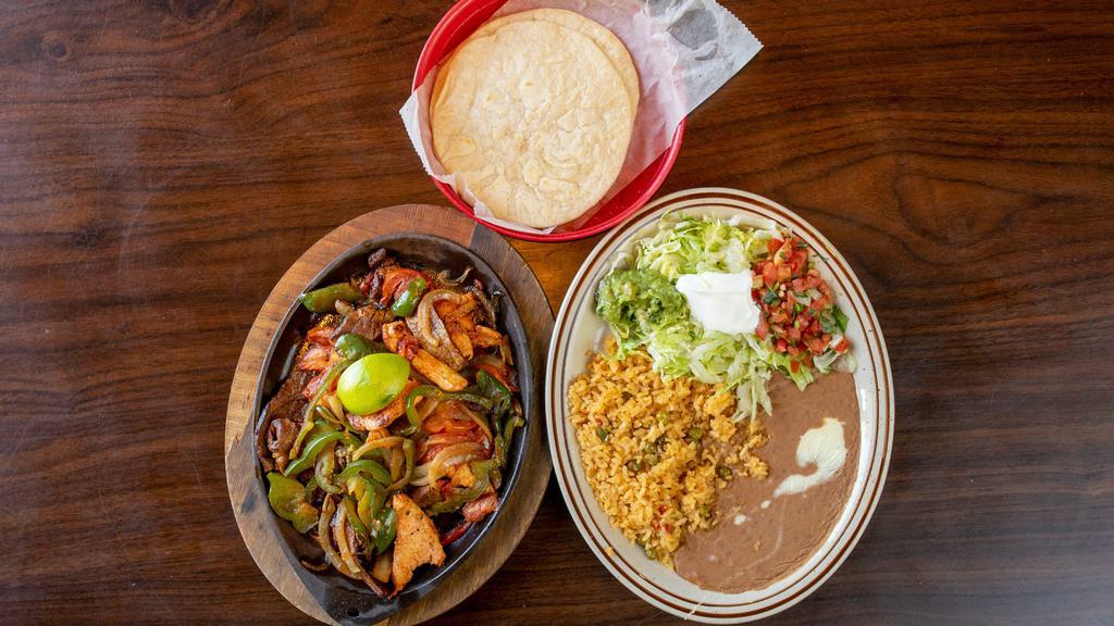 Lunch Fajitas · Grilled chicken or steak, cooked with tomatoes, onions bell peppers. Served with rice, beans, lettuce, sour cream, homemade guacamole, pico de gallo and flour tortillas.