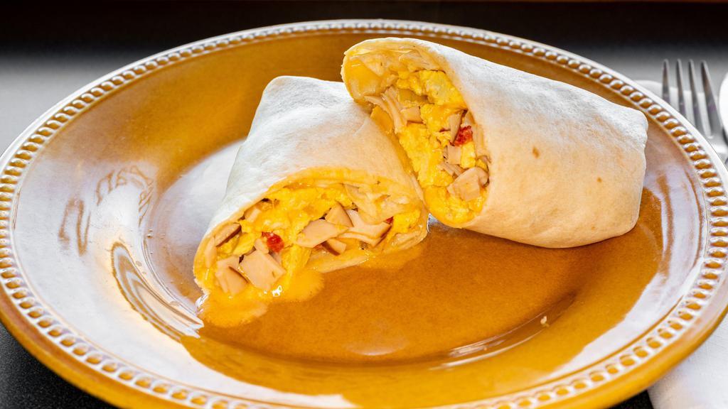 Breakfast Burrito · Scrambled eggs, ham, cheddar, roasted red peppers, onions, mushrooms and house-made Southwest ranch.