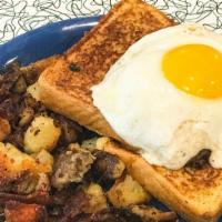 Whole Lotta Goodness · Two slices of french toast topped with a sausage patty, cheese spread, and a sunny side egg....
