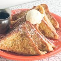 Menage A Trois · 3 slices of thick-cut french toast topped with powdered sugar, butter, and warm syrup.