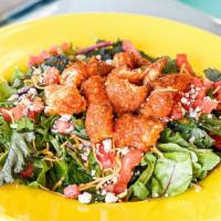 Buffalo Chicken Salad · Buffalo chicken tenders, blue cheese crumbles, cheddar cheese and diced tomatoes on a bead o...