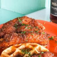 Chicken & Waffles · Fried chicken tenders tossed in a sweet and spicy maple glaze served on top of a buttermilk ...