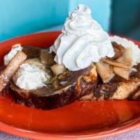 Cinnamon Roll French Toast Sweets · Two slices of grilled cinnamon french toast topped with seasonal fruit, buttercream icing, w...
