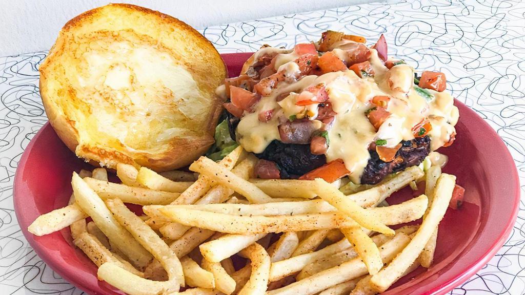 Black Bean Burger Sandwich · Grilled black bean burger on a toasted potato rolland a bed of lettuce. Topped with queso and fresh pico de gallo.