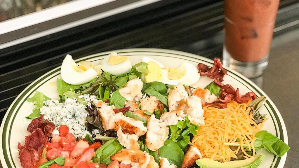 Dr Bob'S Cobb Salad · Grilled chicken, cheddar cheese, blue cheese crumbles, tomato, avocado, hard boiled egg and chopped bacon on a bed of mixed greens.