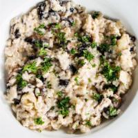 Risotto · Risotto with mushrooms, carved on a wheel of pecorino romano cheese