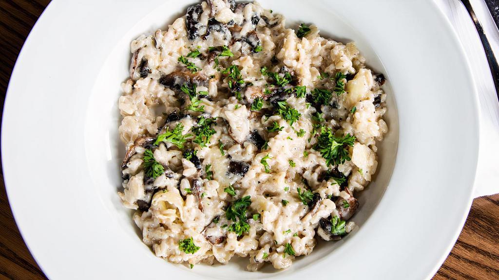 Risotto · Risotto with mushrooms, carved on a wheel of pecorino romano cheese