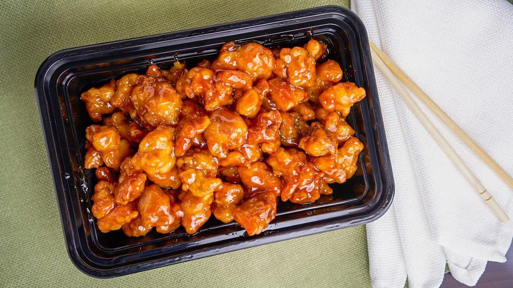 Orange Chicken · Spicy. Tender fillets of marinated chicken delicately sautéed and seasoned with orange flavor. Hot and spicy. Served with white rice.