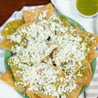 Chips · Chips prepared with salsa verde and queso fresco.