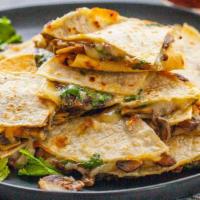 Don Manuel'S Quesadilla · A large flour tortilla filled with eggs, cheese and choice of bacon, ham or chorizo and serv...