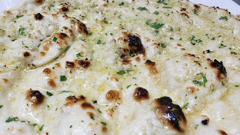 Garlic Naan · Topped with chopped fresh garlic and coriander.