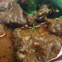 Goat Curry & Rice [Gf] · Goat cooked with onion & tomato based sauce, Herbs & Spices.