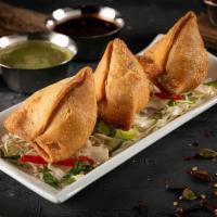 (3) Samosas · Fried pastry dough filled with baked potato, mixed with onions, peas, lentils, and served wi...