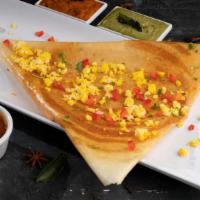 Egg Dosa · A special south Indian folded 'crepe' layered delicately with easy cooked egg, and served wi...