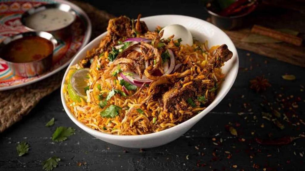 Gongura Goat Dum Biryani · Unique authentic-layered rice dish cooked with goat meat and sour gongura (sorrel leaves), Basmati rice, and exotic spices in true Nawabi style