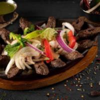 Lamb Seekh Kabab · Minced lamb meat marinated in fresh ground spices and herbs and fire-roasted in clay oven