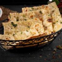 Garlic Naan · Fresh home-made white bread baked with minced garlic & cilantro in clay oven