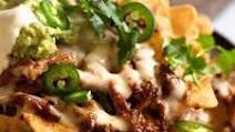 Double Chicken Nachos · Double meat chicken with nacho cheese sauce lettuce tomatoes sour cream onions jalapenos and...