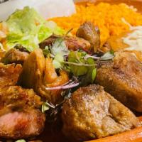 Carnitas · Chunks of pork slow-cooked, served with pico de gallo, black beans and rice.