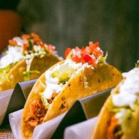 Taco (Hard Shell) · Taco topped with lettuce, cheese, and  pico de gallo