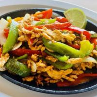 Fajita · Tender strips of steak or chicken marinated in our own special seasoning, grilled with green...