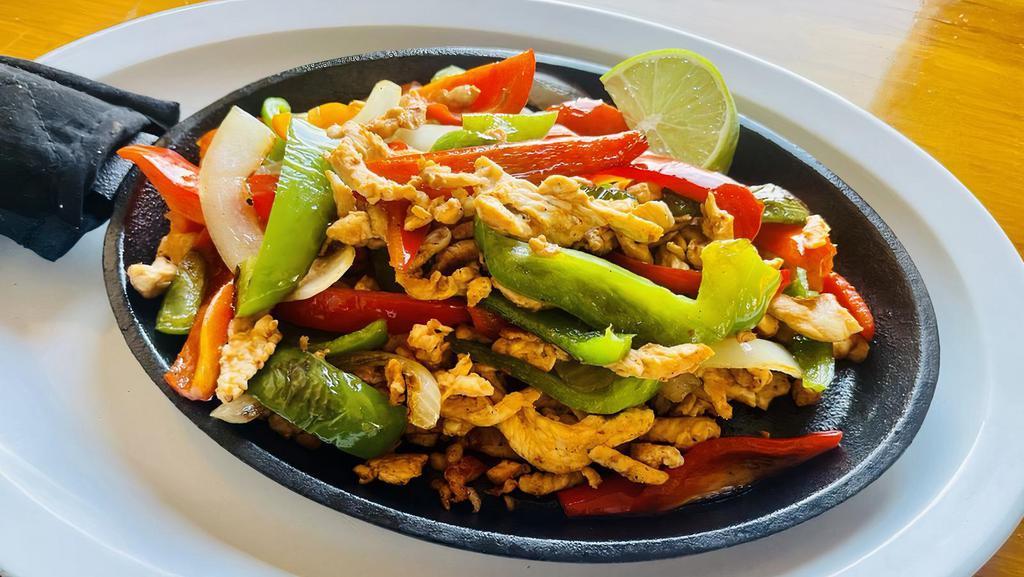 Fajita · Tender strips of steak or chicken marinated in our own special seasoning, grilled with green peppers and onions. Served with Mexican rice, beans, guacamole, pico de gallo, sour cream and your choice of corn or flour tortillas.