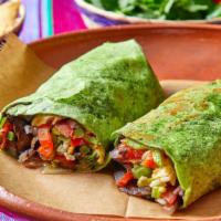Veggie Specialty Burrito · Spinach wrap stuffed with black beans, white rice, grilled bell peppers, onions, tomatoes, m...