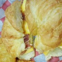 Croissant Sandwich · Two eggs-scrambled, American cheese, and choice of ham, sausage or strips of smoked bacon on...