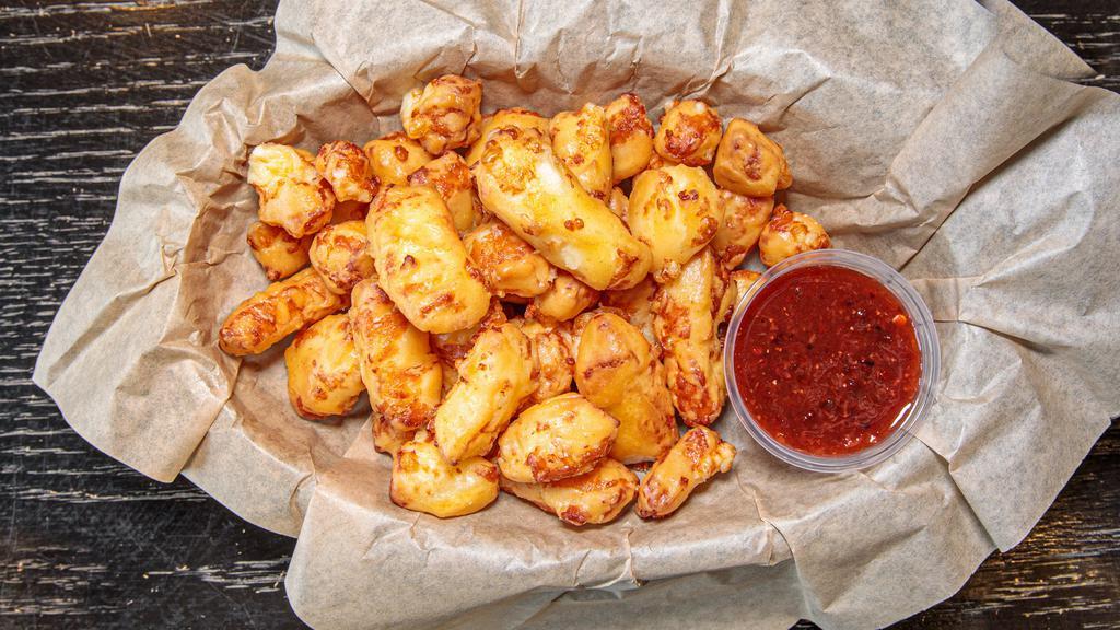 Cheese Curds · Hand battered curds served with strawberry chipotle jam.