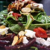 Beet Salad · Made with organic spring mix. Steamed beet salad topped with goat cheese, roasted almonds, a...