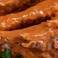 Baby Back Ribs · Costillas de Cerdo 
Our famous Spanish style baby back ribs cooked slowly to a fall of the b...