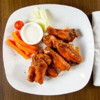 Buffalo Wings · Eight pieces. Carrots and celery.