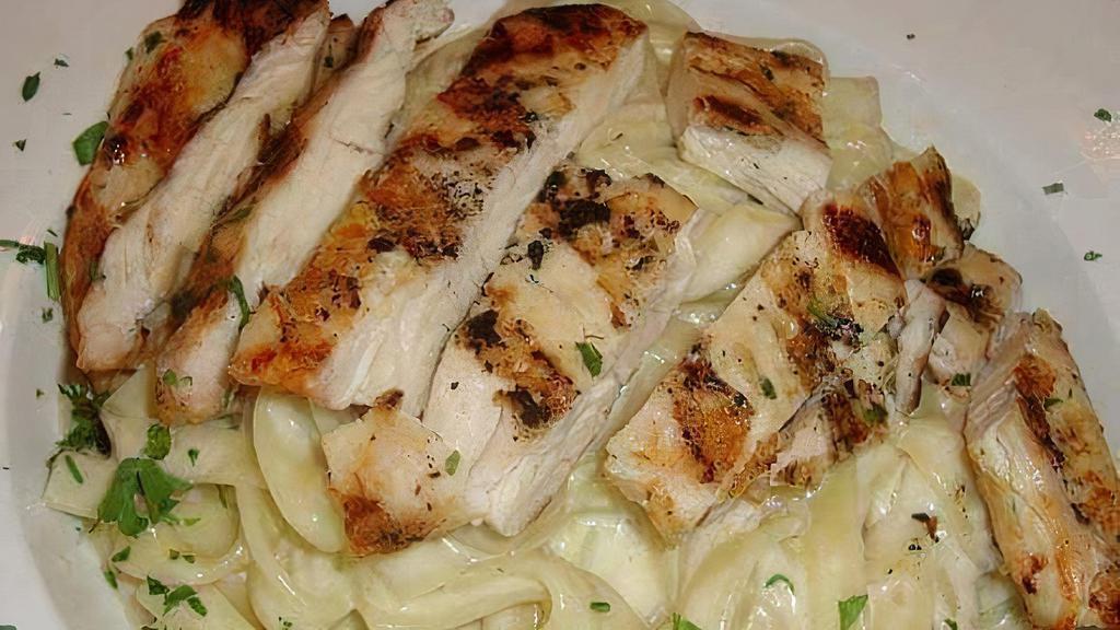 Chicken Alfredo · Seasoned grilled chicken topped with homemade alfredo sauce topped with parmesan flakes and parsley.