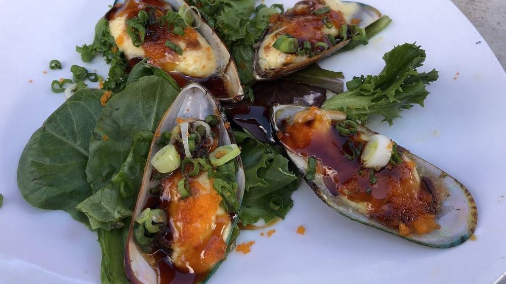 Baked Green Mussels · four New Zealand green mussels topped with dynamite sauce and masago, drizzled with sweet soy sauce