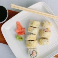 Tootsie Roll · crab sticks, shrimp, & cucumber rolled and topped with crunchy tempura bits, drizzled with s...