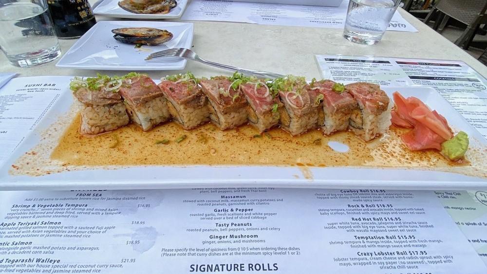 Cowboy Roll · choice of big eye tuna OR lobster mix and asparagus inside, topped with thinly sliced seared steak, served with homemade spicy sauce