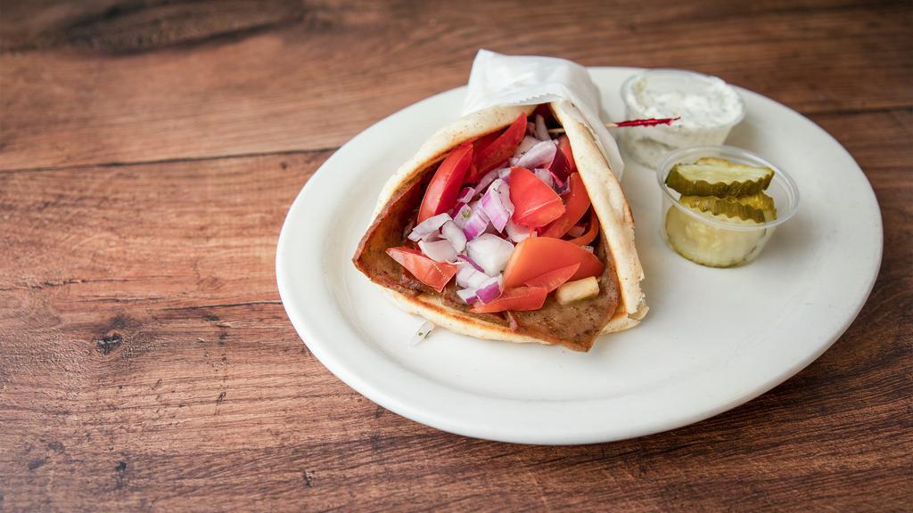 Gyros · Seasoned ground lamb piled high, with mild spanish onions, tomato's  with a side of cucumber sauce Served on a pita.