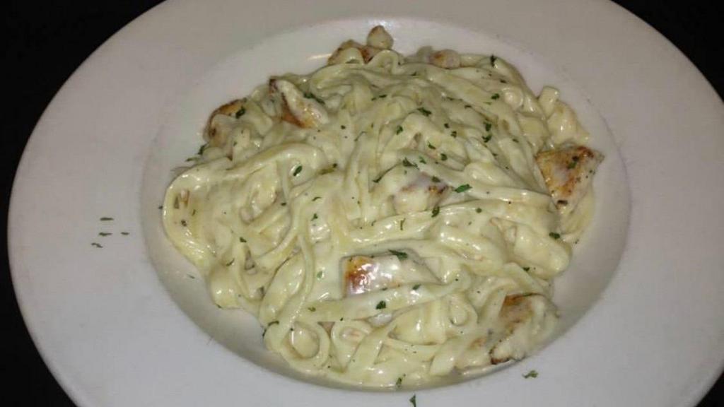 Chicken Fettuccini Alfredo · Grilled chicken smothered in alfredo sauce served with garlic toast. Choice salad or Cole slaw.
