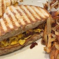 The New Yorker · Scrambled eggs, bacon and cheddar cheese grilled on panini bread. Served. with hash browns
