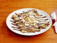 Nutella Banana Crepes · Fresh sliced bananas rolled into three crepes. Topped with a rich Nutella spread