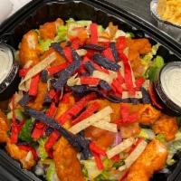 Buffalo Chicken Salad · Spicy Buffalo chicken strips with celery, green peppers, red onions, tortilla strips, Jack a...