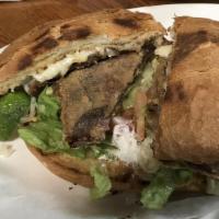 Torta · A Mexican style bun toasted with your choice of meat, lettuce, tomato, onion, avocado, refri...