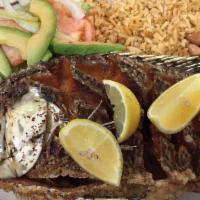 Mojarra Frita · Seasoned whole fried tilapia served with rice, French fries and a small side salad. Also ser...