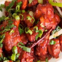 Chicken 65 · Boneless chicken cubes marinated and tossed in spiced yogurt sauce flavored with curry leaves.