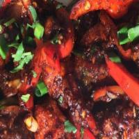 Chili Chicken · Stir-fried boneless chicken with sweet bell peppers, green chilies, onions, and aromatic Ind...